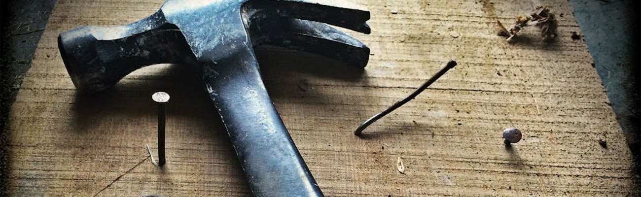 Hammer on board with nails